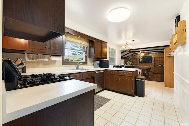 405 Inglenook Pl, Angola, IN 46703 - kitchen featuring under cabinet range hood, a peninsula, light countertops, stainless steel dishwasher, and tasteful backsplash