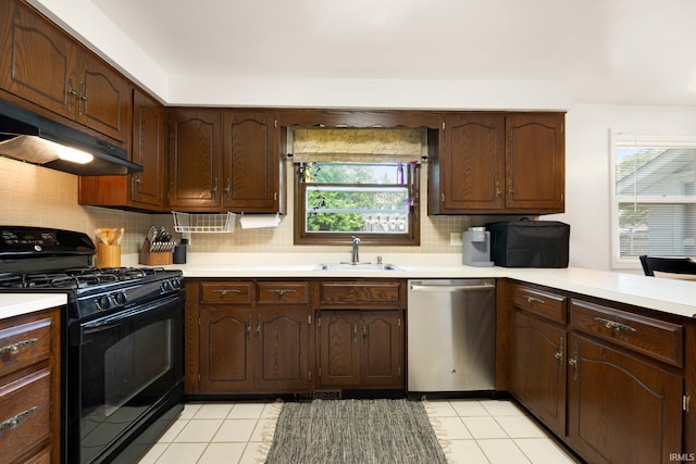 405 Inglenook Pl, Angola, IN 46703 - kitchen featuring stainless steel dishwasher, black range with gas cooktop, a sink, under cabinet range hood, and light countertops