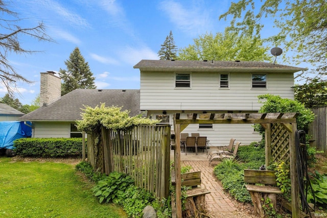 405 Inglenook Pl, Angola, IN 46703 - back of house with a patio area, a chimney, and outdoor dining space