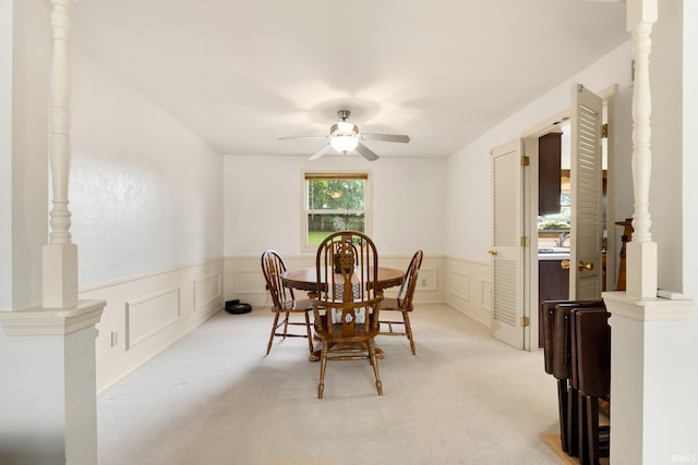 405 Inglenook Pl, Angola, IN 46703 - dining room with a ceiling fan, light carpet, a wainscoted wall, and a decorative wall