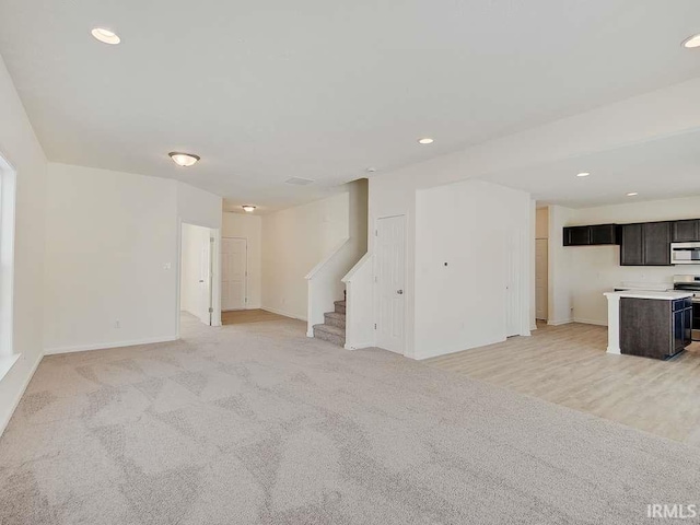 1006 E Brandy Blvd, Ellettsville, IN 47429 - unfurnished living room with stairway, baseboards, recessed lighting, and light carpet