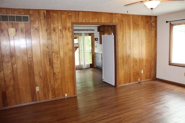 4283 E Ramp Creek Rd, Bloomington, IN 47401 - unfurnished room featuring wooden walls, wood finished floors, a ceiling fan, and baseboards