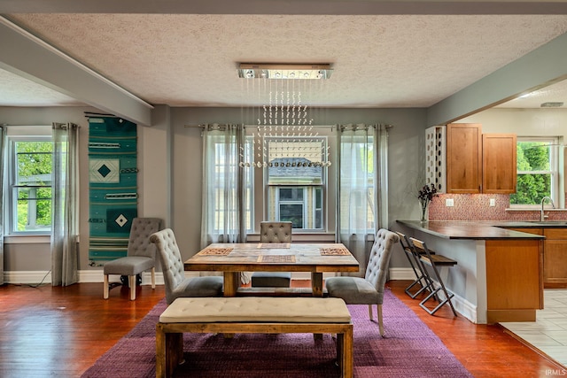 413 Lingle Ave, Lafayette, IN 47901 - dining area with light wood-style flooring, a textured ceiling, and baseboards