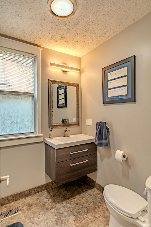 413 Lingle Ave, Lafayette, IN 47901 - bathroom with baseboards, toilet, vanity, and a textured ceiling