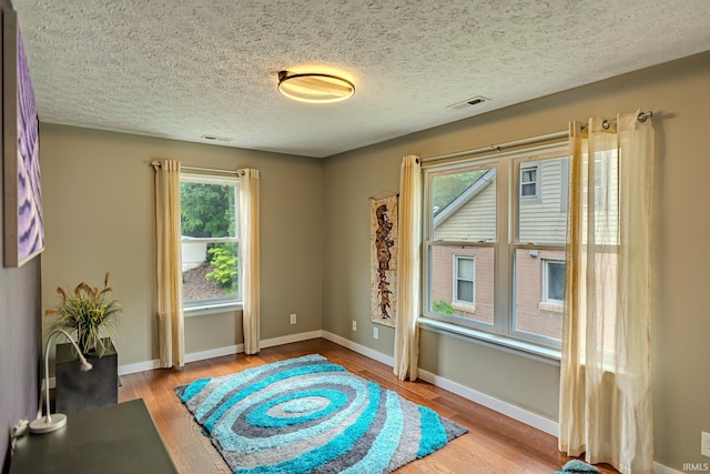 413 Lingle Ave, Lafayette, IN 47901 - living area featuring wood finished floors, baseboards, and a textured ceiling