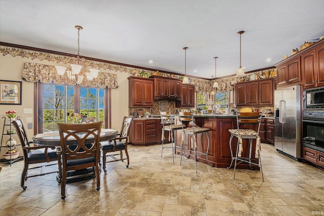 136 Tulip Cir, Bremen, IN 46506 - kitchen featuring black appliances, stone tile floors, a chandelier, a center island, and crown molding