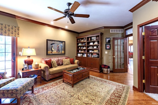 136 Tulip Cir, Bremen, IN 46506 - living room with a ceiling fan, wood finished floors, and crown molding