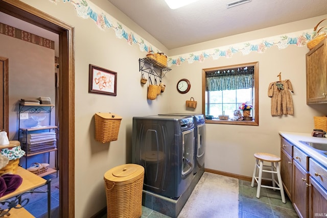 136 Tulip Cir, Bremen, IN 46506 - laundry area featuring cabinet space, washing machine and dryer, and baseboards