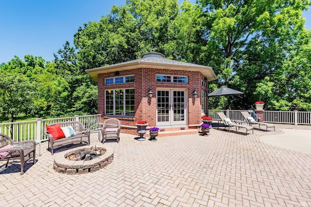 136 Tulip Cir, Bremen, IN 46506 - view of patio / terrace featuring an outdoor fire pit, french doors, and view of scattered trees