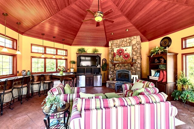 136 Tulip Cir, Bremen, IN 46506 - living area featuring wooden ceiling, plenty of natural light, ceiling fan, a stone fireplace, and high vaulted ceiling