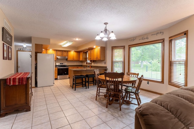 620 Bob Ct, Evansville, IN 47711 - dining space with a chandelier, light tile patterned flooring, a textured ceiling, and baseboards