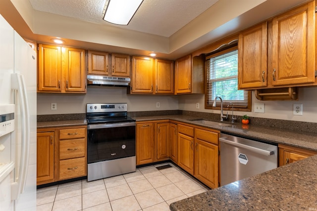 620 Bob Ct, Evansville, IN 47711 - kitchen featuring appliances with stainless steel finishes, under cabinet range hood, a sink, brown cabinetry, and a textured ceiling