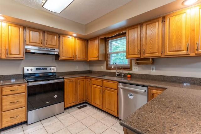 620 Bob Ct, Evansville, IN 47711 - kitchen with appliances with stainless steel finishes, under cabinet range hood, a sink, light tile patterned floors, and brown cabinets