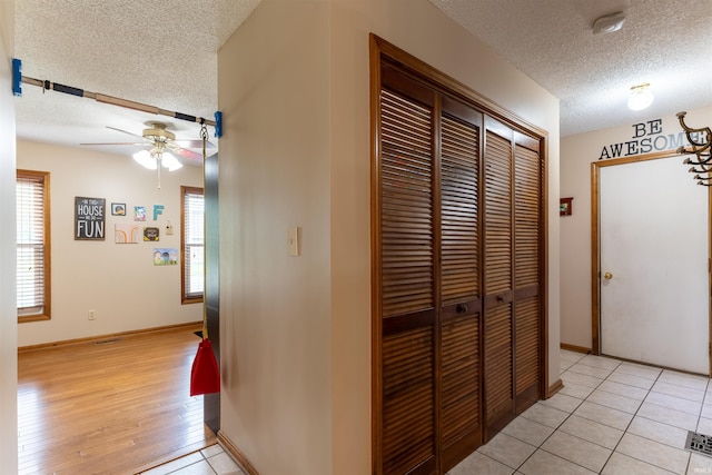 620 Bob Ct, Evansville, IN 47711 - hall featuring a textured ceiling, light wood-type flooring, and baseboards