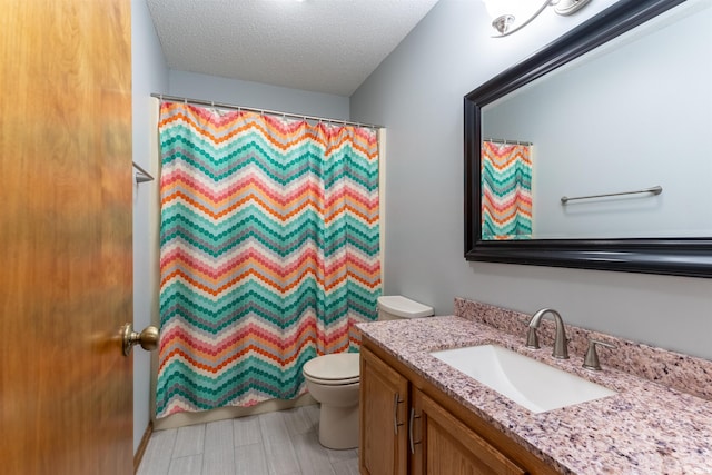 620 Bob Ct, Evansville, IN 47711 - full bath featuring toilet, vanity, a textured ceiling, curtained shower, and wood finished floors