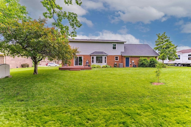 620 Bob Ct, Evansville, IN 47711 - back of property with brick siding, a deck, a yard, and a shingled roof
