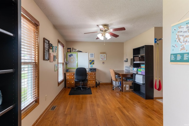 620 Bob Ct, Evansville, IN 47711 - home office featuring a ceiling fan, wood finished floors, healthy amount of natural light, a textured ceiling, and baseboards