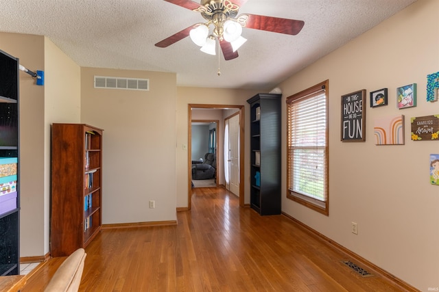 620 Bob Ct, Evansville, IN 47711 - corridor featuring a textured ceiling, light wood-style flooring, plenty of natural light, and baseboards