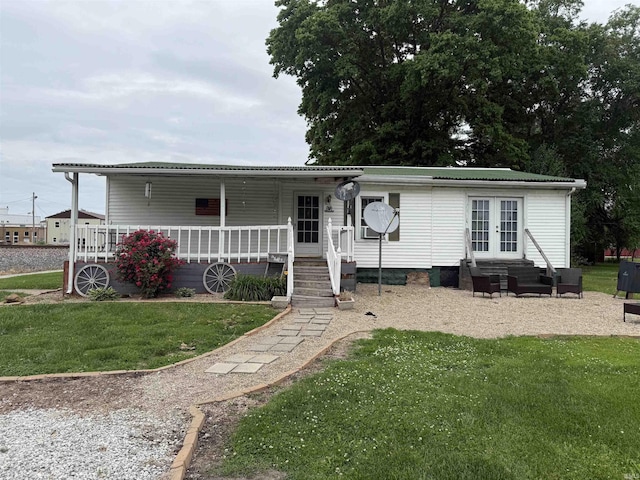 204 S Railroad Ln, Oaktown, IN 47561 - manufactured / mobile home with a front yard, french doors, covered porch, and metal roof