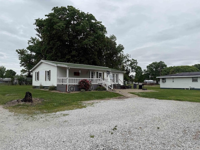 204 S Railroad Ln, Oaktown, IN 47561 - view of front of house featuring covered porch, a front yard, and gravel driveway