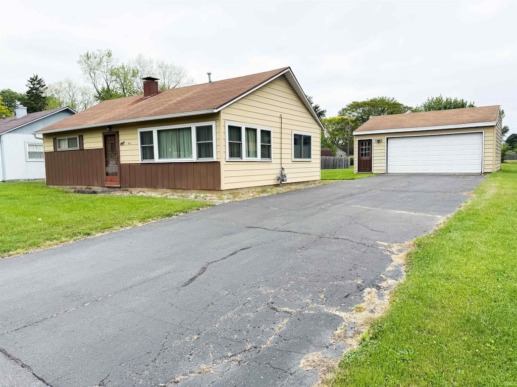 910 Brookdale Dr, New Haven, IN 46774 - view of front of property with a front lawn, a garage, and a chimney