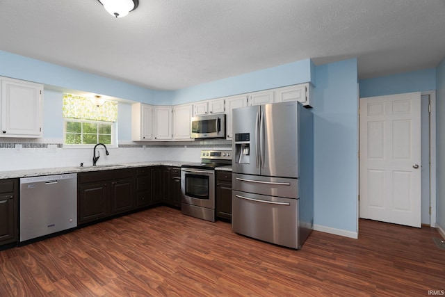 1804 Bent Tree Trl, West Lafayette, IN 47906 - kitchen with stainless steel appliances, a sink, dark wood-style flooring, and backsplash