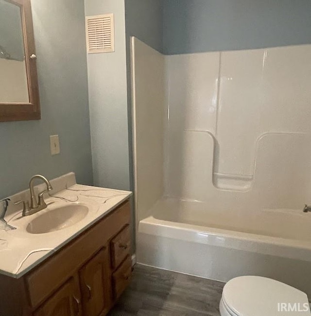 504 V St, Bedford, IN 47421 - bathroom featuring toilet, wood finished floors,  shower combination, and vanity