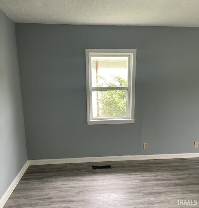 504 V St, Bedford, IN 47421 - spare room with wood finished floors, baseboards, and a textured ceiling