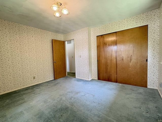 141 Indian Rock Dr, West Lafayette, IN 47906 - unfurnished bedroom featuring wallpapered walls, carpet floors, and a closet