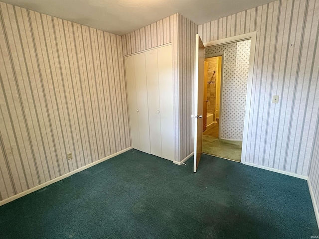 141 Indian Rock Dr, West Lafayette, IN 47906 - unfurnished bedroom with wallpapered walls, a closet, and carpet floors