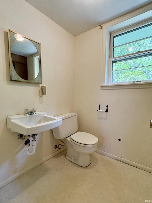 141 Indian Rock Dr, West Lafayette, IN 47906 - half bath featuring toilet, baseboards, and a sink