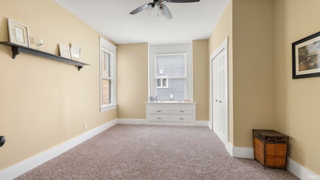 1018 Loree St, Fort Wayne, IN 46805 - unfurnished bedroom with light colored carpet, a closet, a textured ceiling, baseboards, and a ceiling fan
