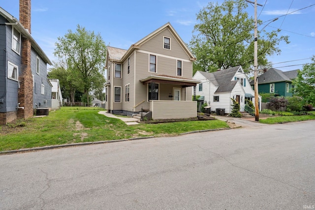 1018 Loree St, Fort Wayne, IN 46805 - view of front facade with a residential view, a front yard, and covered porch