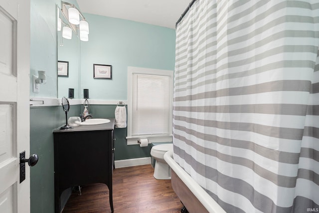 1018 Loree St, Fort Wayne, IN 46805 - bathroom with vanity, wood finished floors, toilet, a bathtub, and a shower with curtain