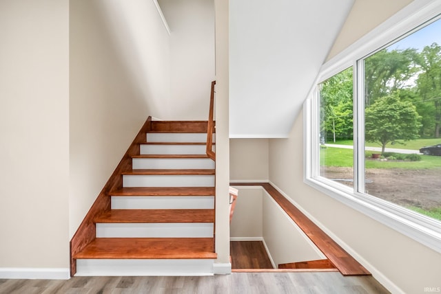 2416 S Woodland Trl, Warsaw, IN 46580 - stairs featuring healthy amount of natural light, lofted ceiling, wood finished floors, and baseboards
