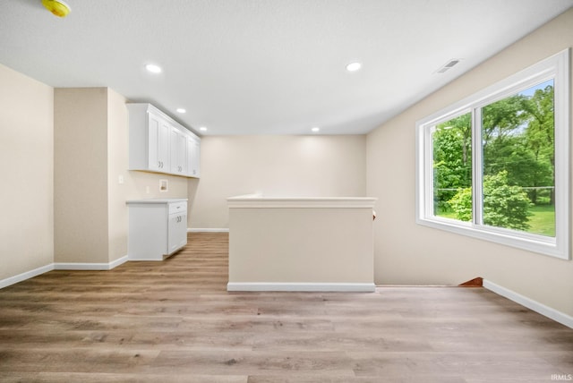 2416 S Woodland Trl, Warsaw, IN 46580 - kitchen with baseboards, white cabinets, recessed lighting, light wood-type flooring, and light countertops