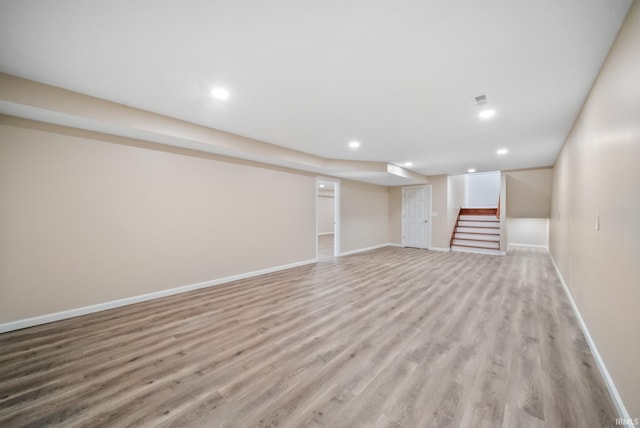 2416 S Woodland Trl, Warsaw, IN 46580 - finished basement featuring light wood-style flooring, stairway, baseboards, and recessed lighting