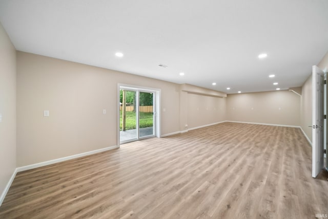 2416 S Woodland Trl, Warsaw, IN 46580 - unfurnished living room with light wood-type flooring, recessed lighting, and baseboards