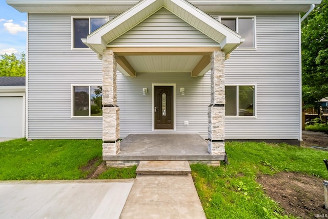 2416 S Woodland Trl, Warsaw, IN 46580 - doorway to property featuring a lawn, a garage, and stone siding