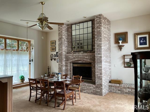 10872 N 875 E, Otterbein, IN 47970 - carpeted dining area featuring a ceiling fan and a fireplace