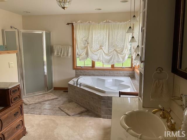 10872 N 875 E, Otterbein, IN 47970 - bathroom featuring a garden tub, a stall shower, vanity, and tile patterned floors