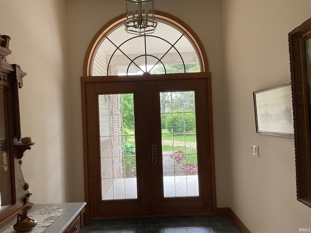 10872 N 875 E, Otterbein, IN 47970 - entrance foyer with french doors, a chandelier, stone tile flooring, and baseboards