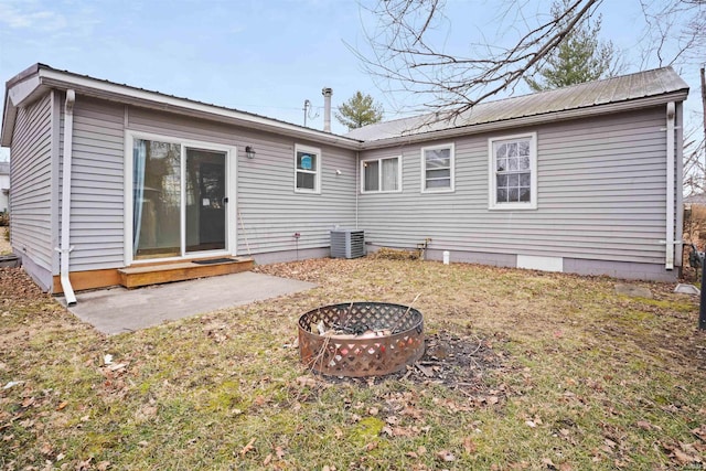 123 S Race St, Princeton, IN 47670 - rear view of house featuring a fire pit, central air condition unit, metal roof, entry steps, and a patio area