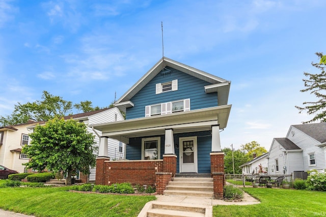 4325 S Wayne Ave, Fort Wayne, IN 46807 - view of front of home with covered porch, brick siding, and a front yard