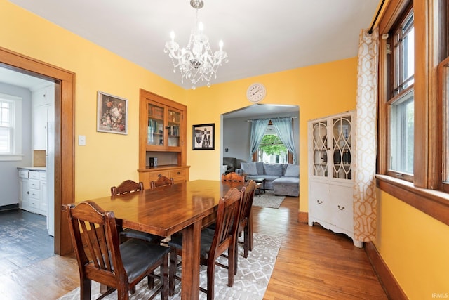 4325 S Wayne Ave, Fort Wayne, IN 46807 - dining space with light wood finished floors, a chandelier, and baseboards
