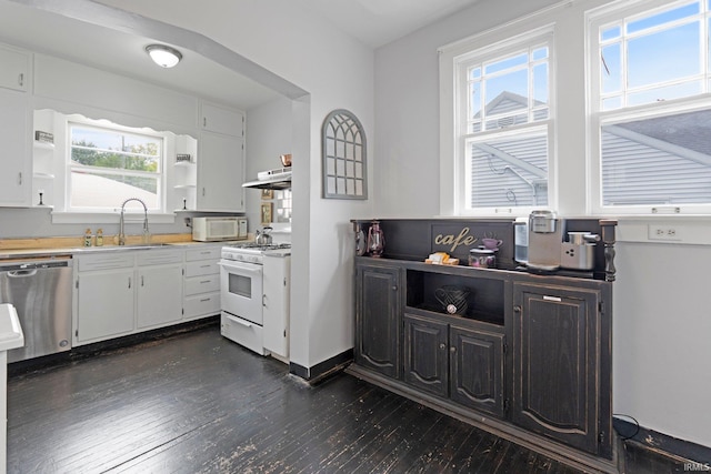 4325 S Wayne Ave, Fort Wayne, IN 46807 - kitchen with white appliances, a sink, dark wood-style flooring, under cabinet range hood, and white cabinetry