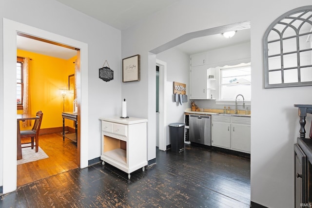 4325 S Wayne Ave, Fort Wayne, IN 46807 - kitchen with stainless steel dishwasher, a sink, dark wood finished floors, and light countertops