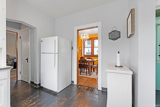 4325 S Wayne Ave, Fort Wayne, IN 46807 - kitchen featuring freestanding refrigerator, dark wood finished floors, a chandelier, white cabinets, and light countertops