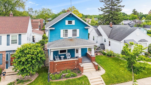 4325 S Wayne Ave, Fort Wayne, IN 46807 - view of front facade featuring a porch, central AC, a front lawn, and roof with shingles