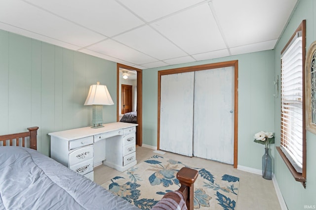 4325 S Wayne Ave, Fort Wayne, IN 46807 - bedroom with multiple windows, a paneled ceiling, a closet, and baseboards
